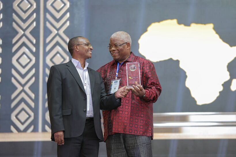 Joshua Chiira receiving award on behalf of Mayfair Insurance